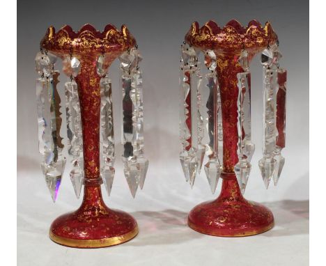 A pair of 19th century ruby glass lustres, gilded scrolling decoration, clear faceted drops, each 30cm high 