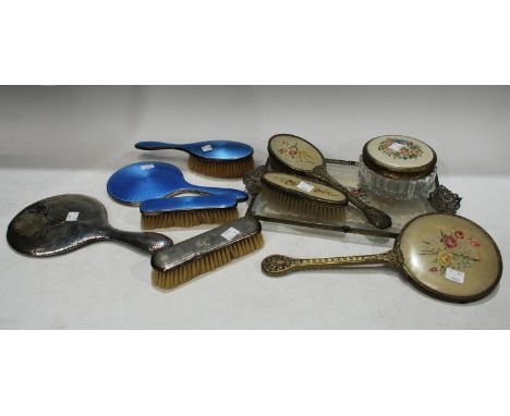 A hallmarked silver and blue enamel backed three piece dressing table set; a hallmarked silver clothes brush; a hallmarked si