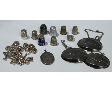 A silver charm bracelet; a silver thimble; a sterling silver ring; metal thimbles; decanter labels; qty 