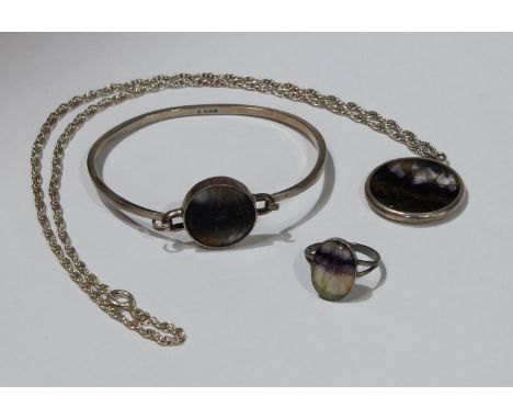 Jewellery - a blue john inset silver bangle, Sheffield 1979,  similar ring and disc pendant necklace (3) 