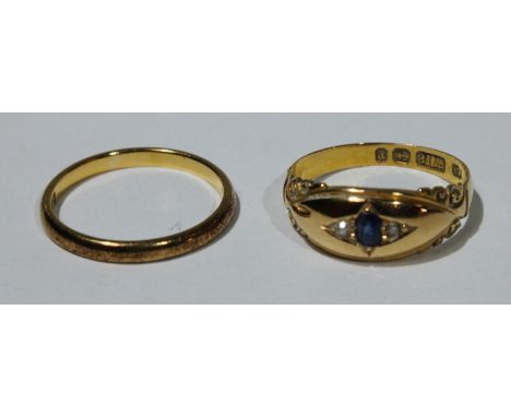 A 22ct gold wedding band, 2.4g; an 18ct gold ring, set with a sapphire and diamond chips, 2.7g (2) 