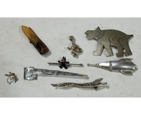 A novelty pewter rocket ship brooch, monogrammed SCA; an Art Deco German chrome Scottie dog arrow brooch; a silver and enamel