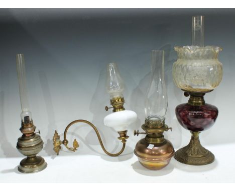 Lighting - a Victorian brass and amethyst glass oil lamp, clear glass floral shade;  a single branch brass wall sconce, milk 