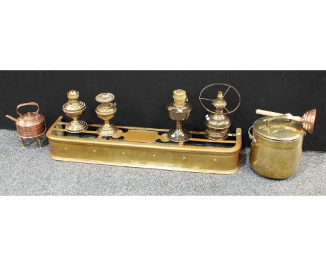 A late 19th century brass fender, 122cm wide; a cylindrical brass log bin and cover; a copper kettle and brass trivet; a copp