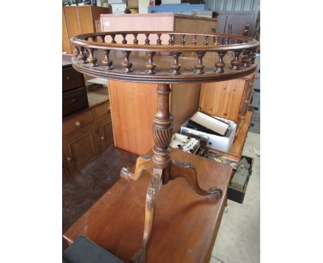 Geo.III style mahogany tripod wine table with baluster turned galleried circular top on three floral carved outsplayed legs D