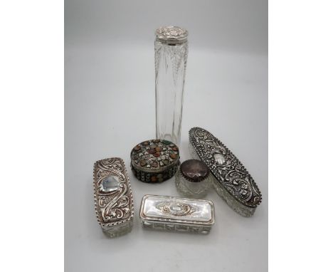 Collection of cut glass dressing table jars with hallmarked sterling silver repoussé decorated lids and a small lined trinket