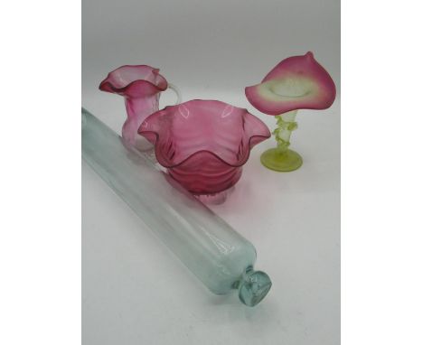 19th C glass rolling pin L. 46cm, cranberry glass bowl with crimped edges on shell shaped moulded feet, a similar jug and a V