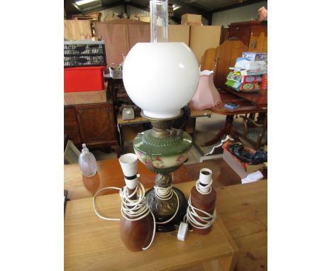 Table lamp in the form of an oil lamp on glazed pottery base decorated with flowers, and two other teak table lamps (3) 