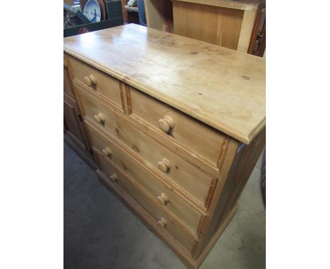 Solid pine chest of two short and two long drawers with turned wooden handles on shaped base W91cm D45cm H100cm 