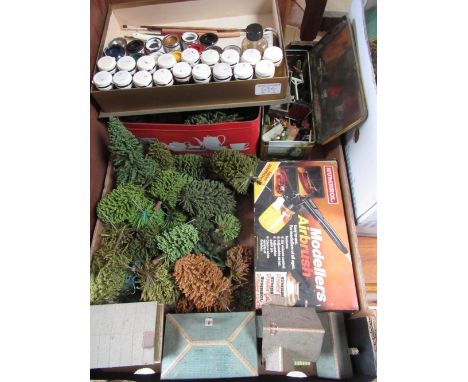 Humbrol modellers airbrush, quantity of enamel and other paints and a collection of railway accessory trees and buildings, et