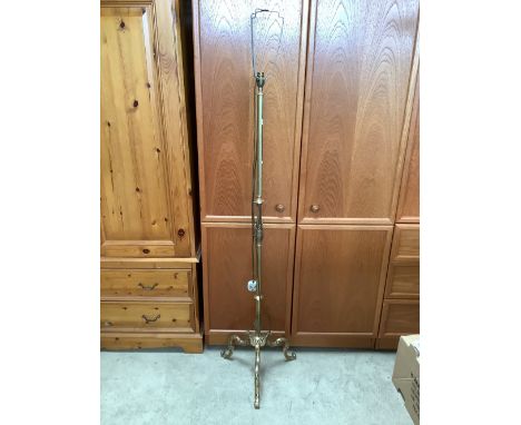 Bronzed standard lamp with ornate C scroll legs and foliage ornamentation 