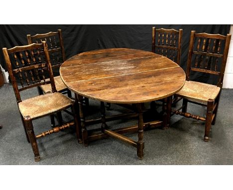 A set of four raffair seated spindle back Lancashire style dining chairs; an oak gate leg table, oval top. (5)