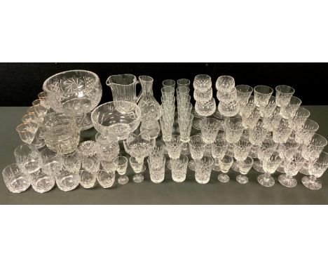 A large cut glass pedestal bowl; another footed bowl; a part suite of cut glass glasses including champagne flutes, hock, red