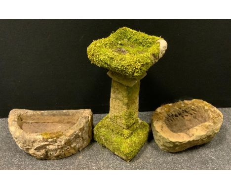 A reconstituted stone bird bath square top, tapering column, stepped base, 60cm high, 27cm wide;  two gritstone trough plante