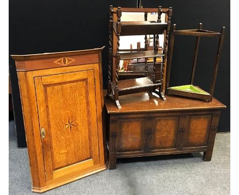 An oak three tier open bookcase/stand; an oak stick stand; an oak framed mirror; a George III oak corner cabinet (no back); a