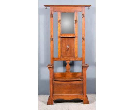 An Edwardian Oak Hall Stand, with moulded edge to top, the back inset with bevelled mirror panel, and six coat hooks, with sh