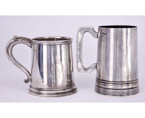 Two George V Silver Tankards, one by Walker & Hall, Sheffield 1925, of cylindrical form with reeded base and angular scroll h