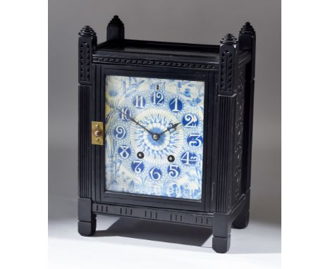 A 19th Century Aesthetic Movement Ebonised and Porcelain Inset Mantel Clock in the Manner of Lewis Forman Day, with blue and 