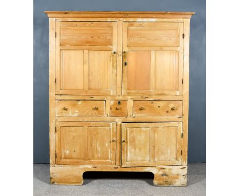 A Late 19th Century Panelled Pine Cupboard, with moulded edge to top, the upper part fitted one shelf enclosed by a pair of p