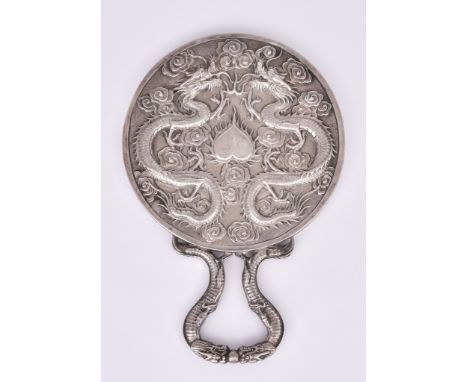 A Chinese Silvery Metal Backed Hand Mirror, chased and cast with dragons, cloud motifs, and heart shaped cartouche, and with 