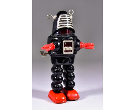 A Yoshiya, Japan, Tin Plate "Planet Robot", Circa 1960s, in black with red hands and feet, with key, 9ins high