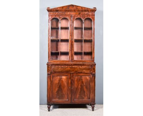 A William IV Figured Mahogany Bookcase, the upper part with architectural cornice, plain frieze, fitted three shelves enclose