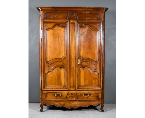 A Late 19th Century French Provincial Oak Armoire, with moulded cornice, plain frieze, fitted two shelves enclosed by a pair 