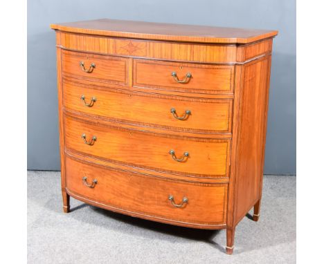 An Edwardian Satinwood and Inlaid Bow and Breakfront Chest with cross banding to top, fitted two short and three long drawers