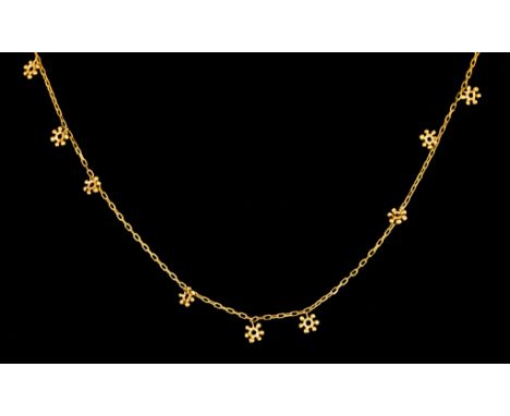 A 14ct Longuard Chain, with suspended snow flakes, retailed by Liberty, 960mm overall, total gross weight 6.4gThe item presen