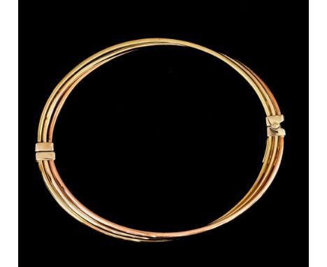A 9ct Gold Hinged Bangle, two coloured, 55mm internal diameter, gross weight 6.8gThe bangle presents in excellent overall con