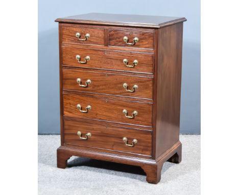 A George III Figured Mahogany Chest, with moulded edge to top, fitted two short and four long graduated drawers, on bracket f