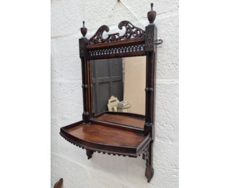 A small early 20th century mahogany mirror back hanging shelf,&nbsp;with fretwork decoration, 67 x 34.5cm. 