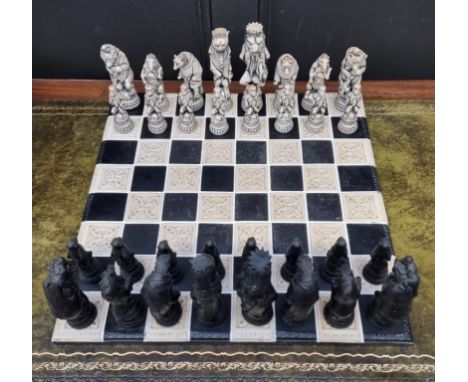 A large resin chess set,&nbsp;king 19cm, pawn 10.7cm; together with similar 55cm chessboard. 