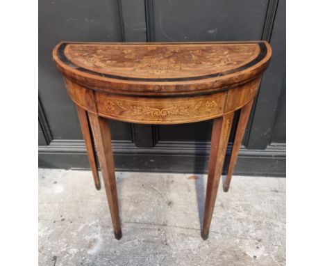 A late 18th century Dutch walnut and marquetry demi-lune card table, with double gateleg action, 76cm wide.&nbsp; 