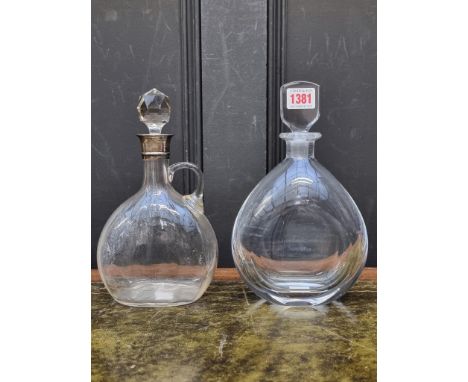 An Orrefors clear glass decanter and stopper,&nbsp;25cm high; together with another silver mounted clear glass decanter and s