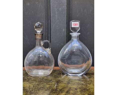 An Orrefors clear glass decanter and stopper,&nbsp;25cm high; together with another silver mounted clear glass decanter and s