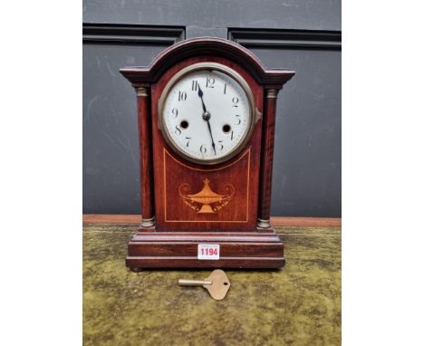 An Edwardian mahogany and inlaid mantel clock, 32cm high, with pendulum.&nbsp; 