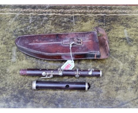 A WWI military flute, stamped broad arrow, in leather case, inscribed 'Leatheries Ltd, 1916'. 