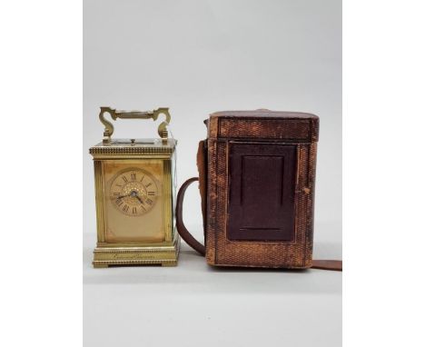 A good antique brass carriage clock, with push button repeat and gong strike, height including handle 19cm, in leather travel