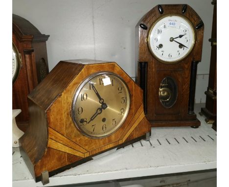 An early 20th century oak case mantel clock with ebonised pillars, white enamel dial and striking movement, height 15"; a chi