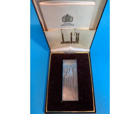 A Dunhill cigarette lighter, engine turned and monogrammed, with original box and paperwork; a leather dome top jewellery box