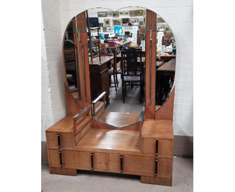 An Art Deco light oak dressing table, chrome mounts with electric lights and plate glass centre shelf, with heart shaped trip