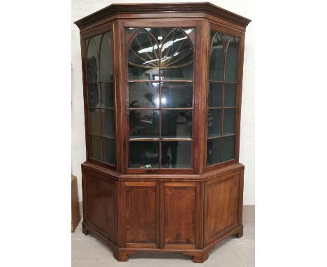 A large Georgian inlaid and crossbanded mahogany canted front full height display cabinet, the upper section with moulded and
