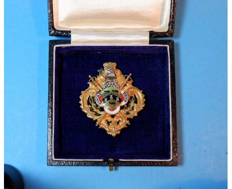 A medallion in 9 carat hallmarked gold and coloured enamel, bearing the crest of Huddersfield, presented to Miss Helen Robins