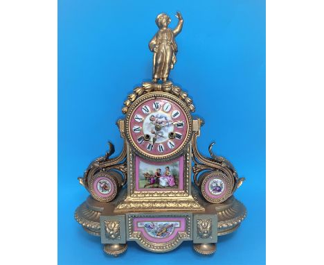 A 19th century Louis XV style ormolu mantel clock with Sevres panel in pink and polychrome and figural finial, French drum mo