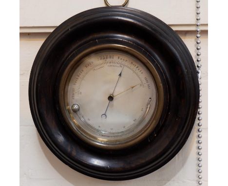 A 19th century aneroid barometer with silvered dial and curved thermometer, ebonsed case, 9" 