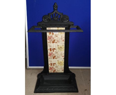 A Victorian cast iron stick stand with tile back 