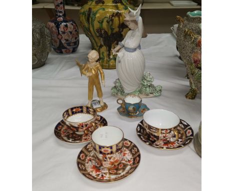 A Royal Worcester figure "The Parakeet"; a Nao figure:  girl with bird; a cabinet cup and saucer 