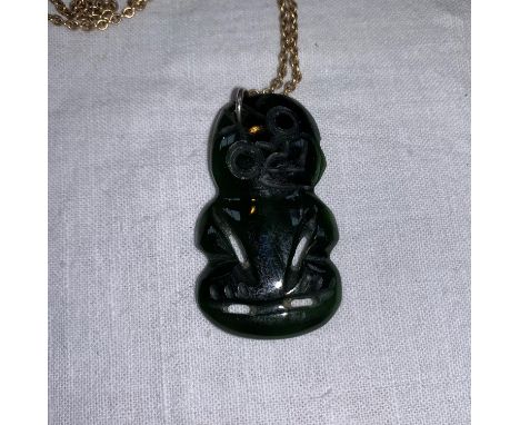 A Maori Tiki pendant in jade coloured hardstone 