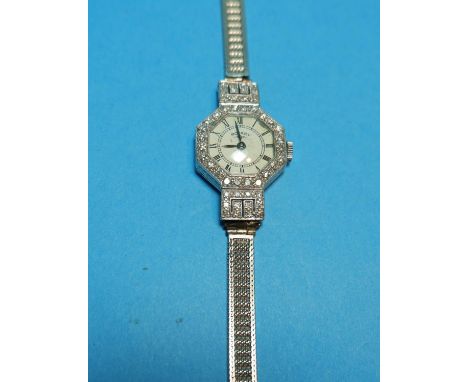 A Rotary white metal lady's cocktail watch stamped 'PLATINUM', the octagonal bezel set with 24 diamonds, the strap loops each